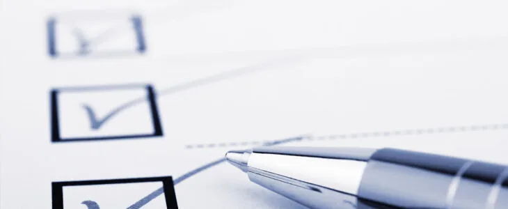 close-up of a checklist or survey being completed with a pen.